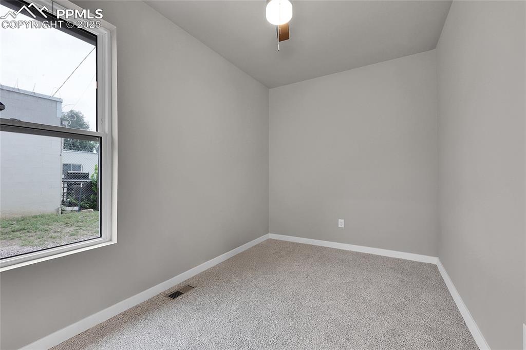 Image 8 of 15: Spare room featuring light carpet and baseboards