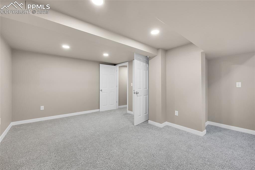 Image 9 of 15: Finished below grade area with light colored carpet and recessed lighting