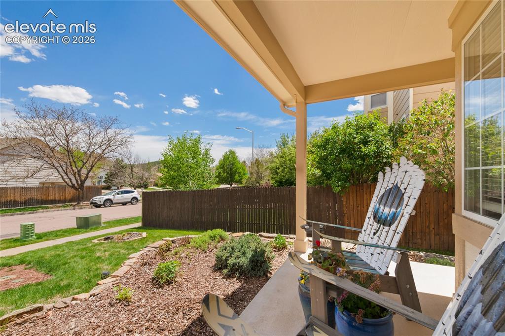 Image 3 of 50: Actually a sweet front porch where you can wave at your neighbors as they w