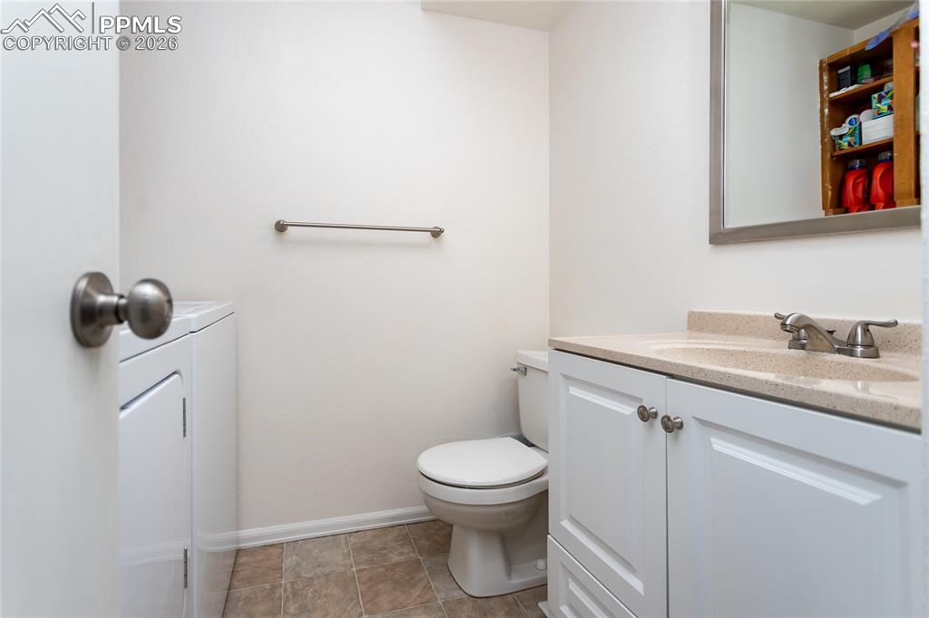 Image 10 of 30: Half bathroom featuring vanity and toilet
