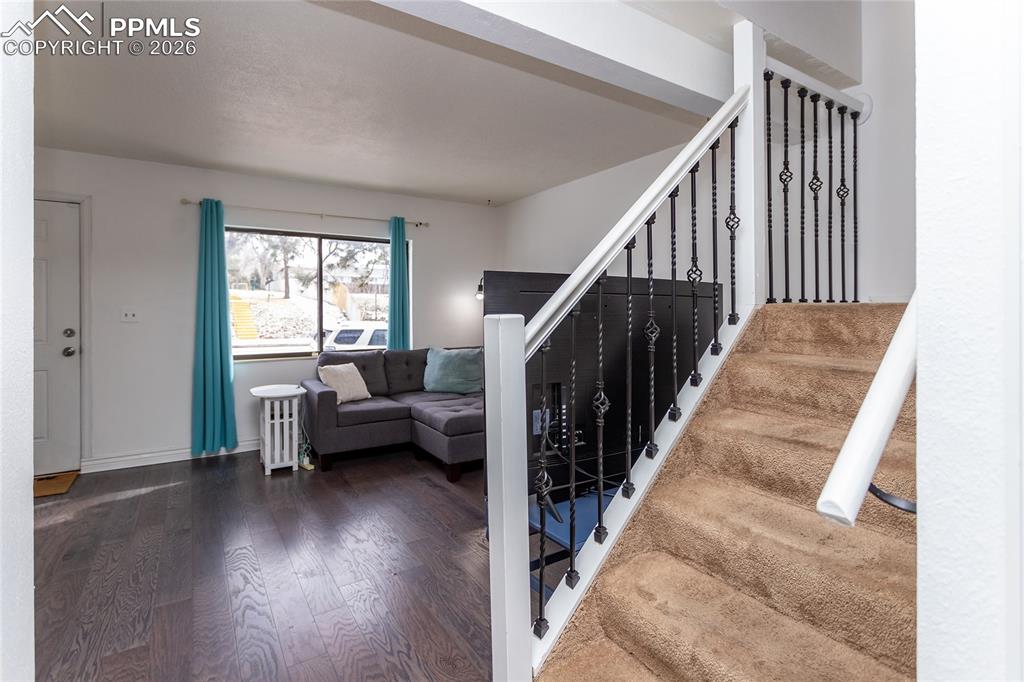Image 9 of 30: Stairway featuring wood finished floors and baseboards
