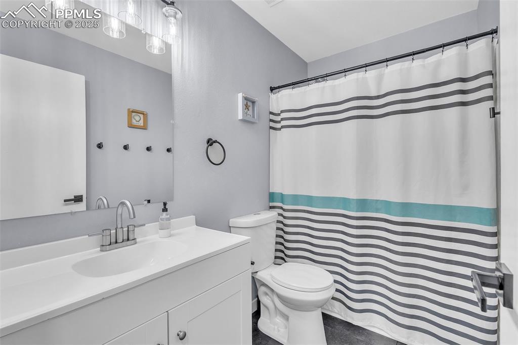 Image 16 of 26: Bathroom featuring vanity and a shower with curtain
