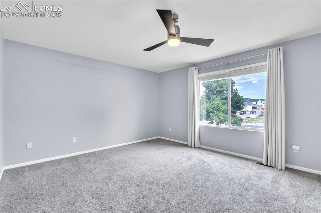 Image 17 of 26: Empty room with carpet and a ceiling fan