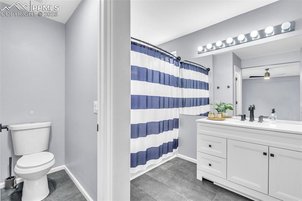 Image 19 of 26: Bathroom featuring vanity and dark tile patterned floors