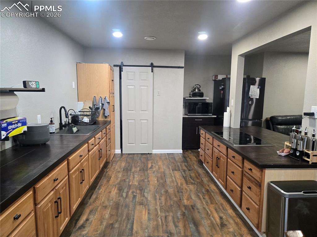 Image 9 of 22: Barn door to kitchen pantry
