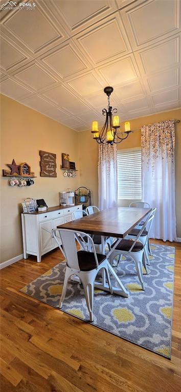 Image 10 of 48: Dining room featuring an ornate ceiling, a chandelier, and light wood finis