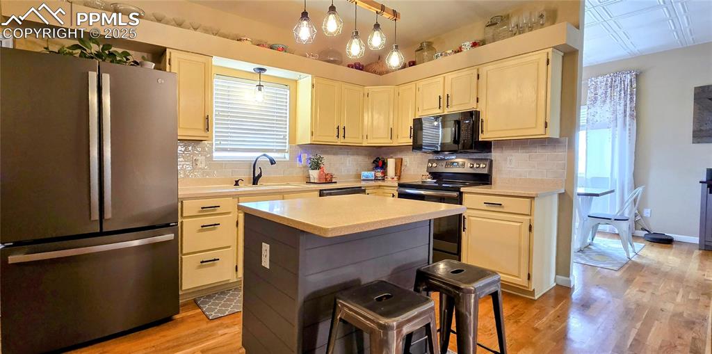Image 13 of 48: Kitchen featuring stainless steel appliances, light wood-style flooring, de