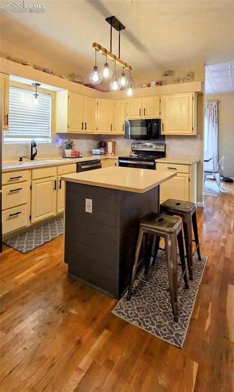 Image 16 of 48: Kitchen with decorative backsplash, light wood-type flooring, and stainless