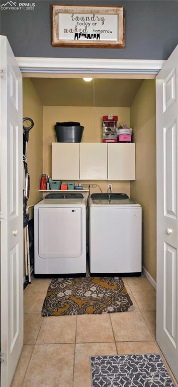 Image 26 of 48: Laundry room with light tile patterned flooring and washing machine and clo