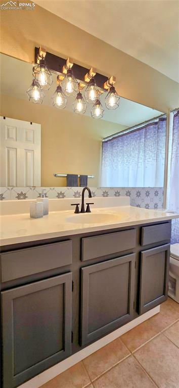 Image 35 of 48: Full bath featuring vanity and light tile patterned floors