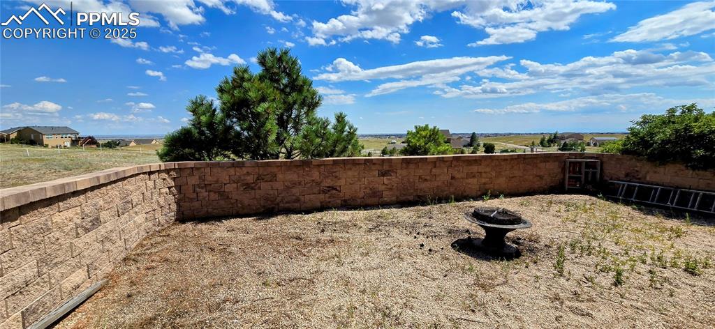 Image 42 of 48: View of yard featuring an outdoor fire pit