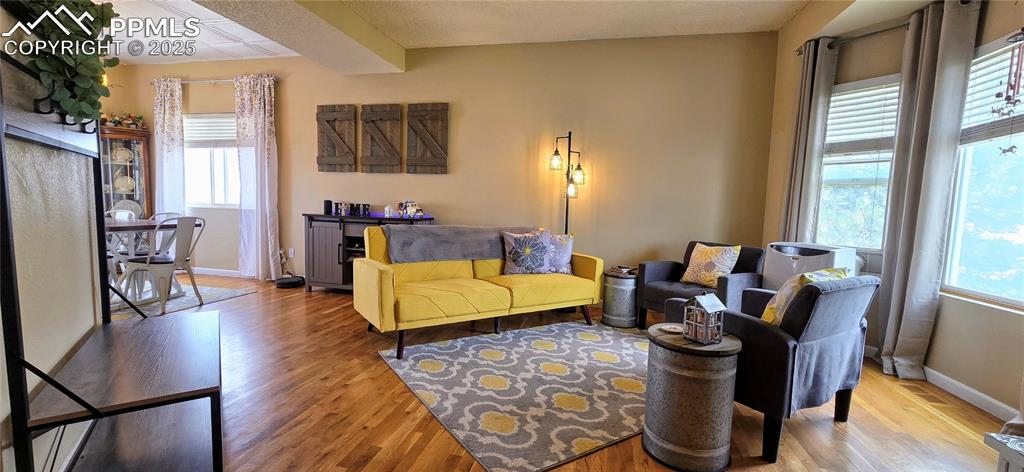 Image 7 of 48: Living area with light wood finished floors