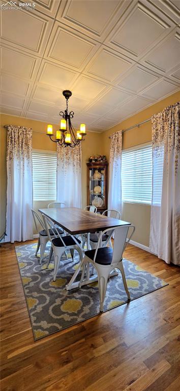 Image 9 of 48: Dining area featuring a chandelier, an ornate ceiling, and light wood-type