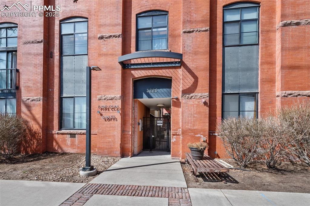Caption: View of exterior entry with brick siding
