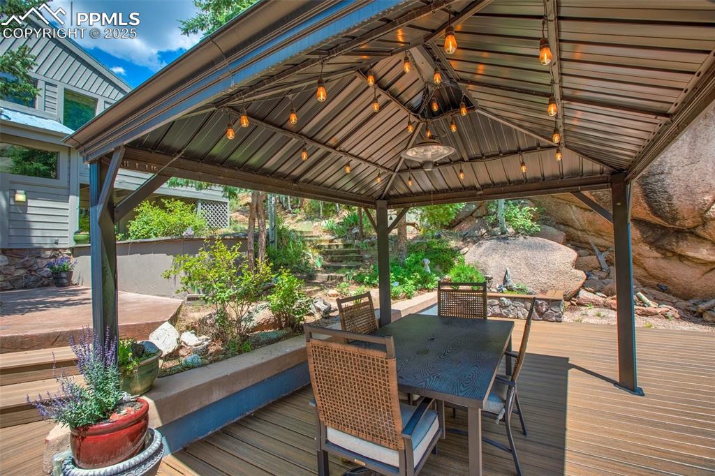 Image 15 of 50: Large deck with gazebo, fountain, firepit