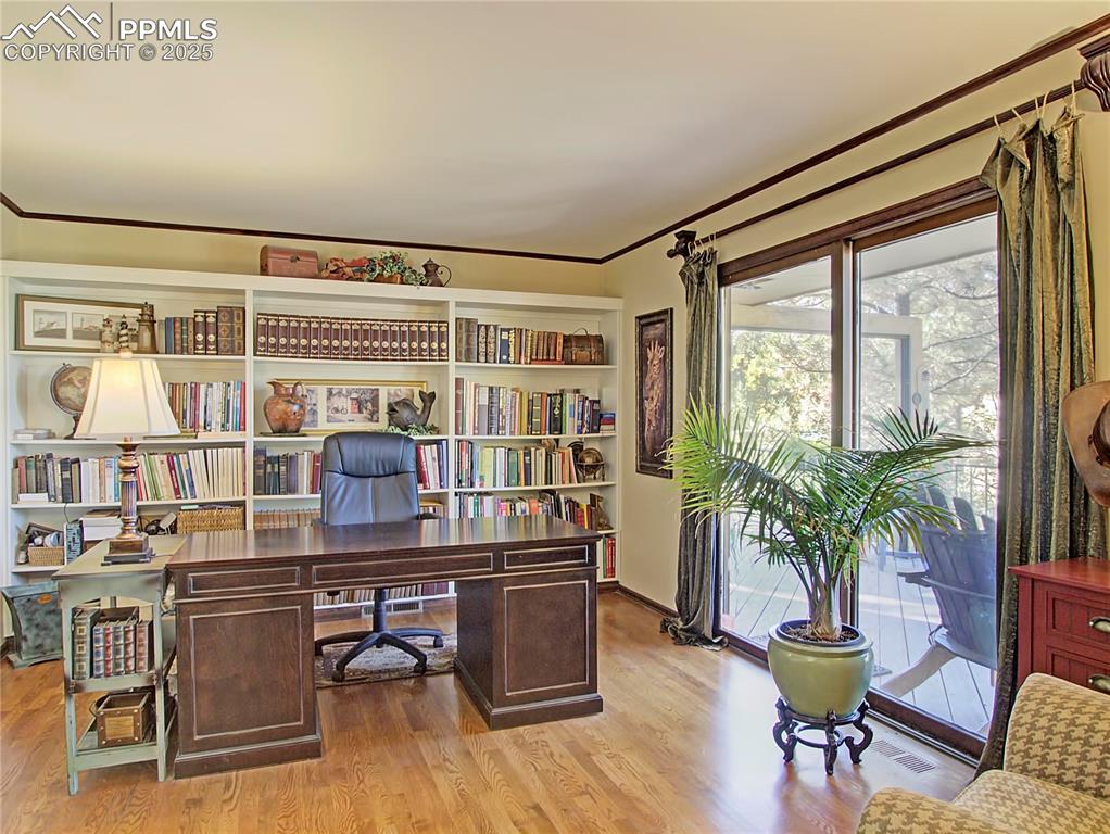 Image 16 of 41: Home office with light wood-type flooring and ornamental molding
