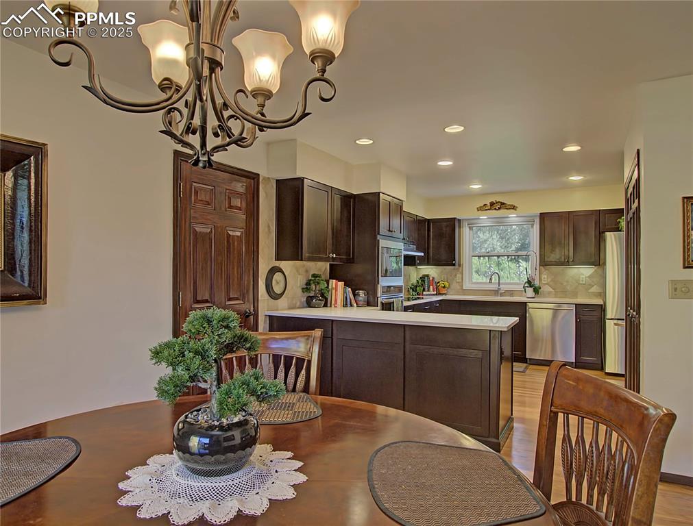 Image 20 of 41: Dining space featuring recessed lighting, a chandelier, and light wood-styl