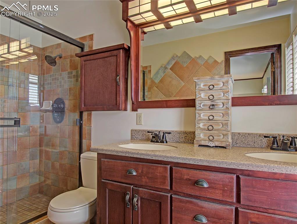 Image 26 of 41: Full bath featuring double vanity and a shower stall