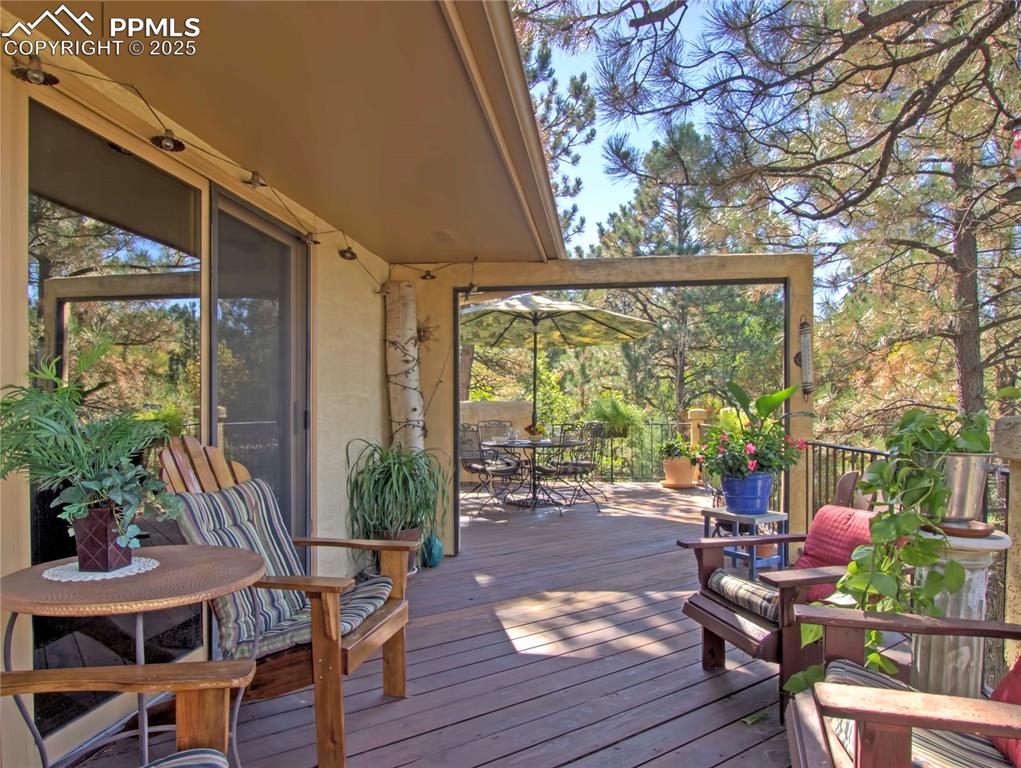 Image 28 of 41: Wooden terrace featuring outdoor dining area