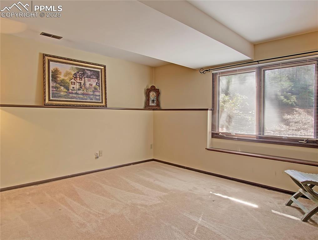 Image 33 of 41: Empty room featuring baseboards and light colored carpet