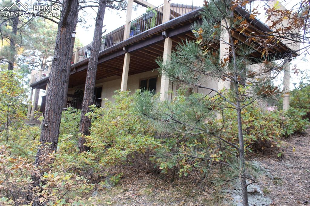 Image 40 of 41: View of property exterior with stucco siding and a wooden deck