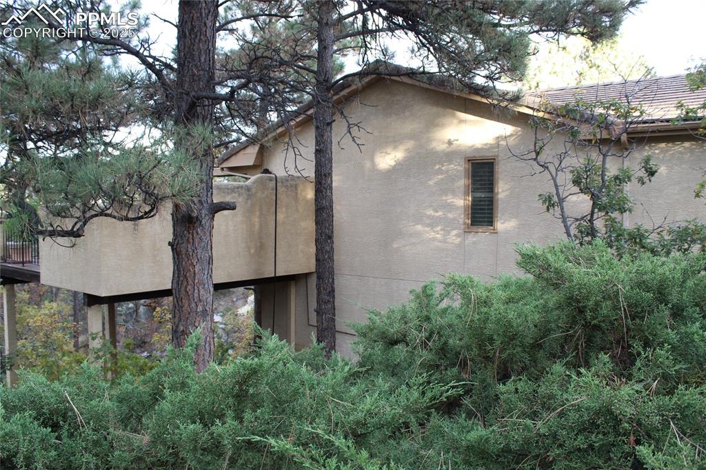 Image 41 of 41: View of side of property with stucco siding
