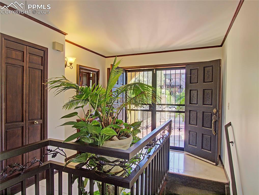 Image 5 of 41: Tiled entrance foyer with ornamental molding