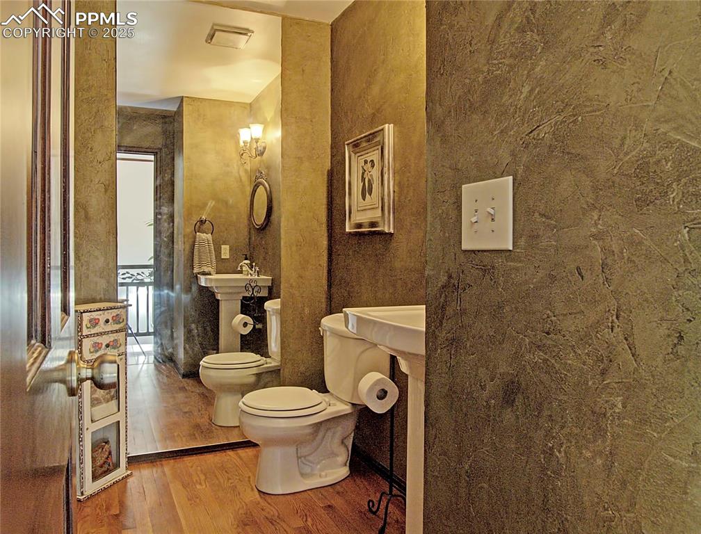 Image 6 of 41: Bathroom with wood finished floors and toilet