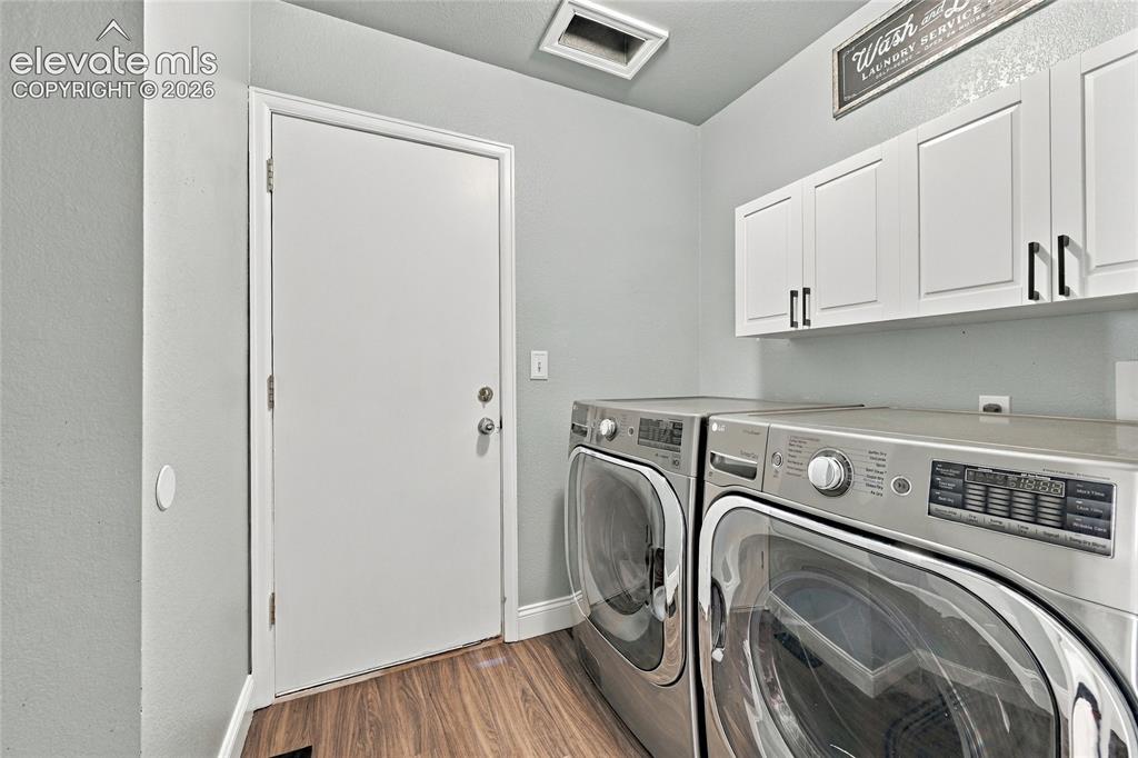 Image 17 of 45: Wood look vinyl plank flooring with light gray wall paint, white overhead c