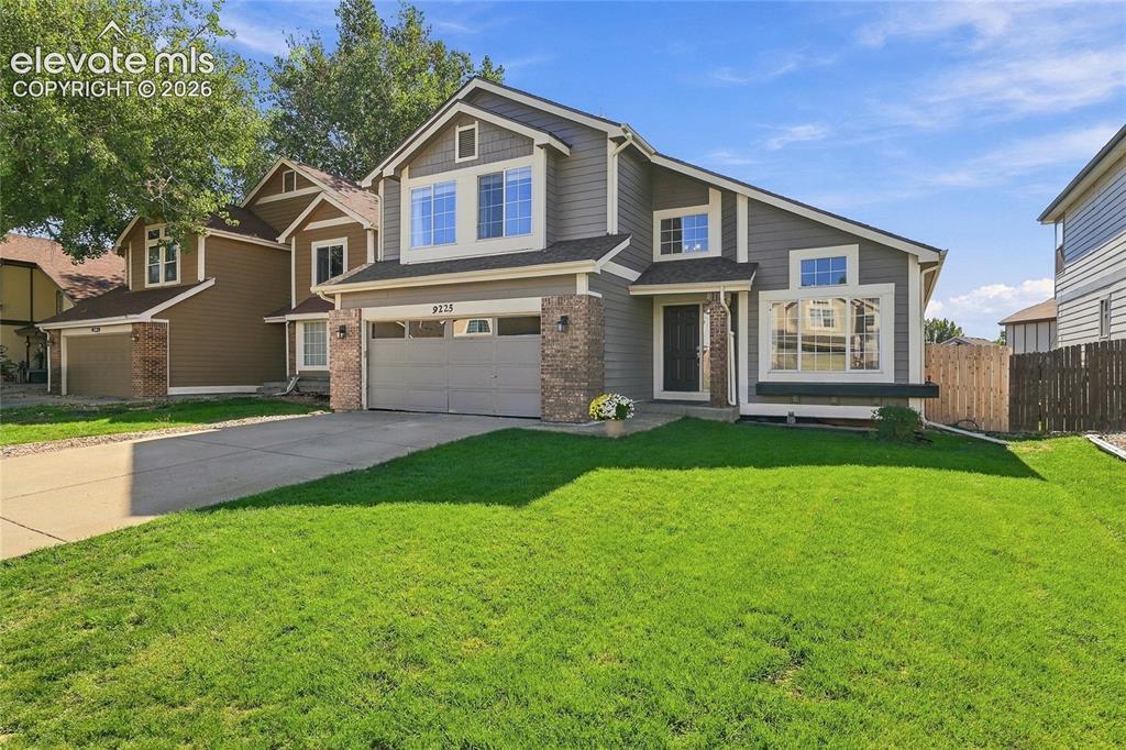 Image 3 of 45: Multi-level residence featuring gray siding with white trim accents, a two-