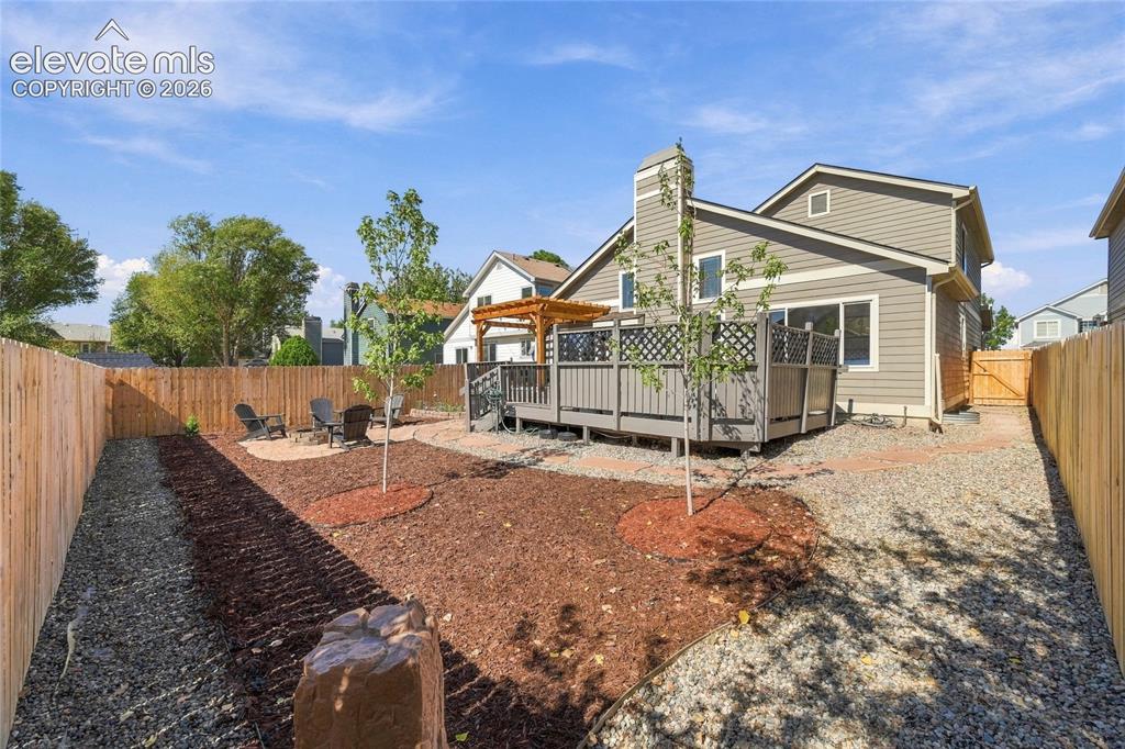 Image 36 of 45: Expansive backyard with thoughtful landscaping