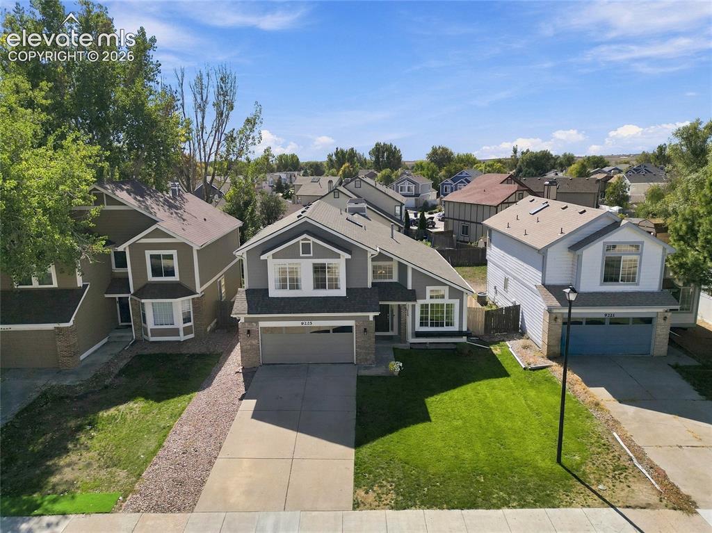 Image 39 of 45: Two-story home featuring a two-car garage with a nice front lawn in an esta