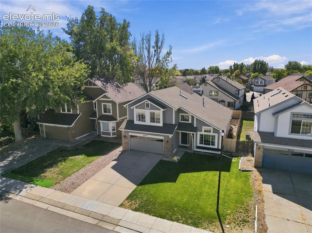 Image 40 of 45: Two-story home featuring a charcoal exterior with white trim, arched entryw