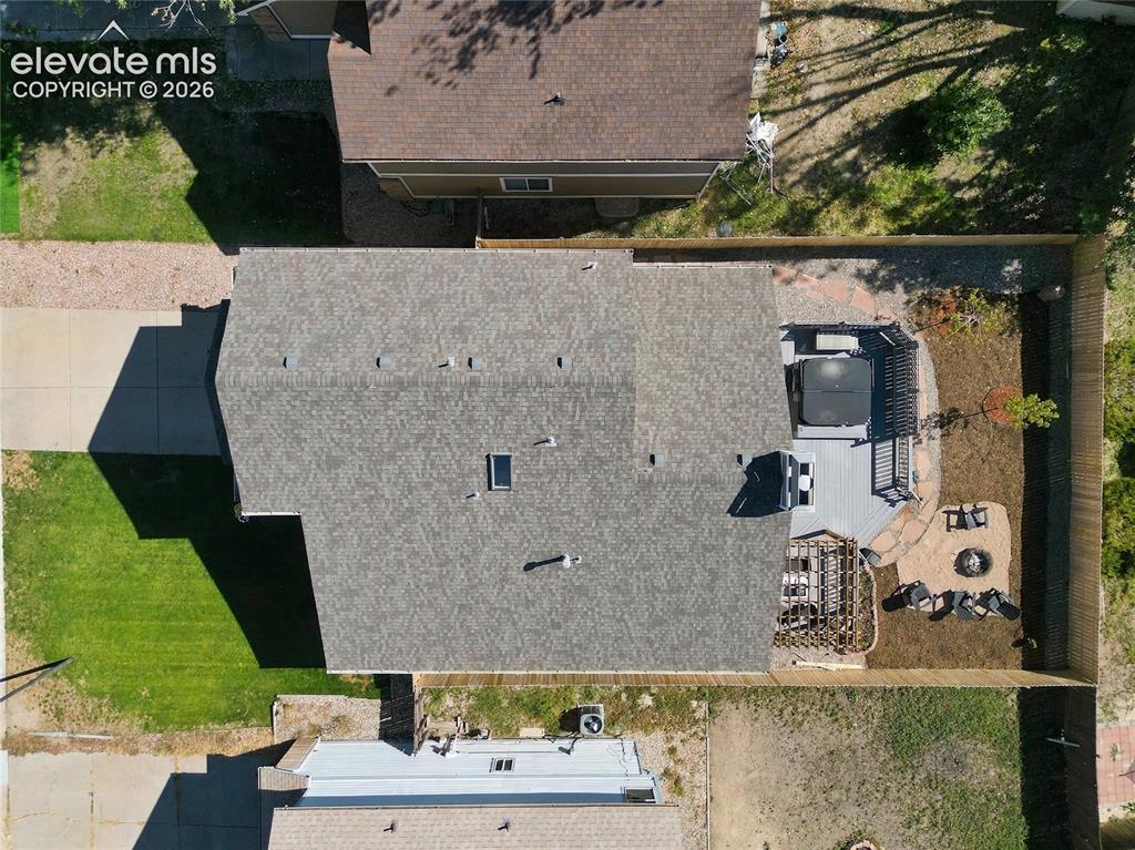 Image 41 of 45: Aerial view showcasing a residential property with a spacious roof featurin