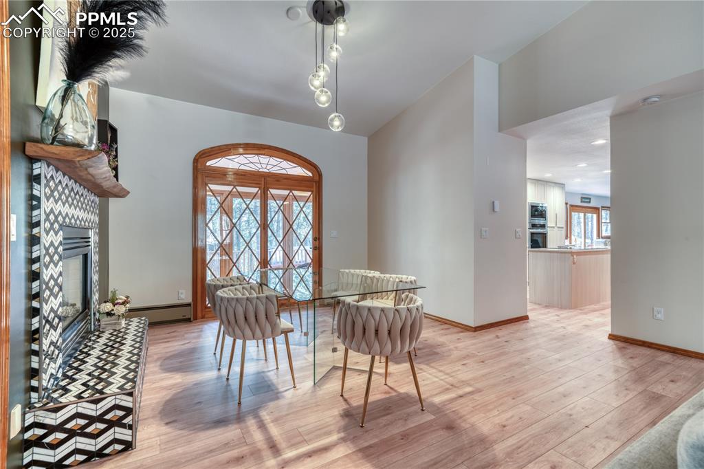 Image 10 of 50: Dining space with lofted ceilings