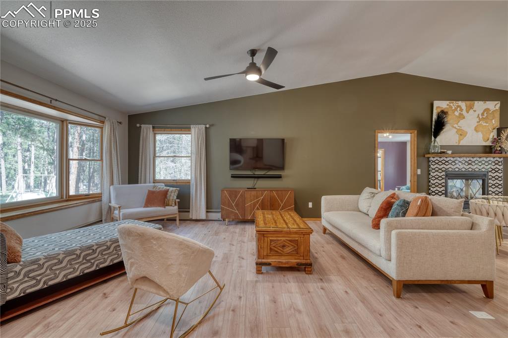 Image 5 of 50: Living area with lofted ceiling