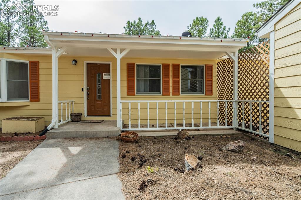 Image 7 of 50: Entrance to property with covered porch