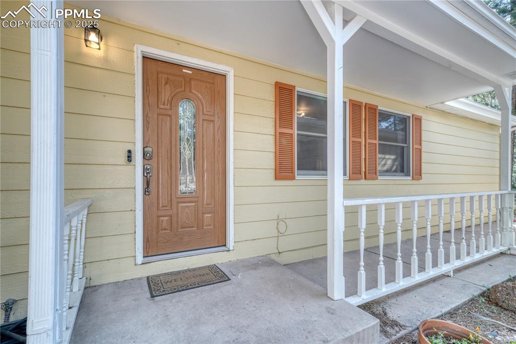 Image 8 of 50: Entrance to property with covered porch
