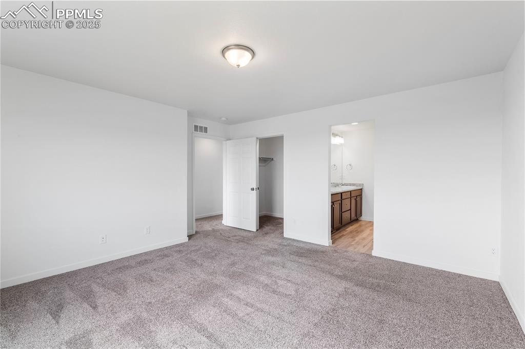 Image 12 of 39: Large primary bedroom has a separate attached 3/4 bath