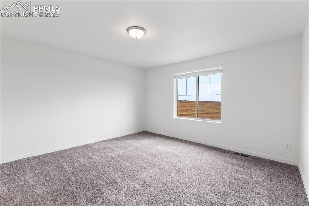 Image 13 of 39: Another view of primary bedroom