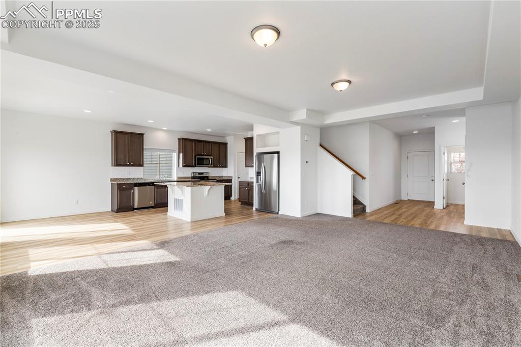 Image 5 of 39: Living room opens to the kitchen