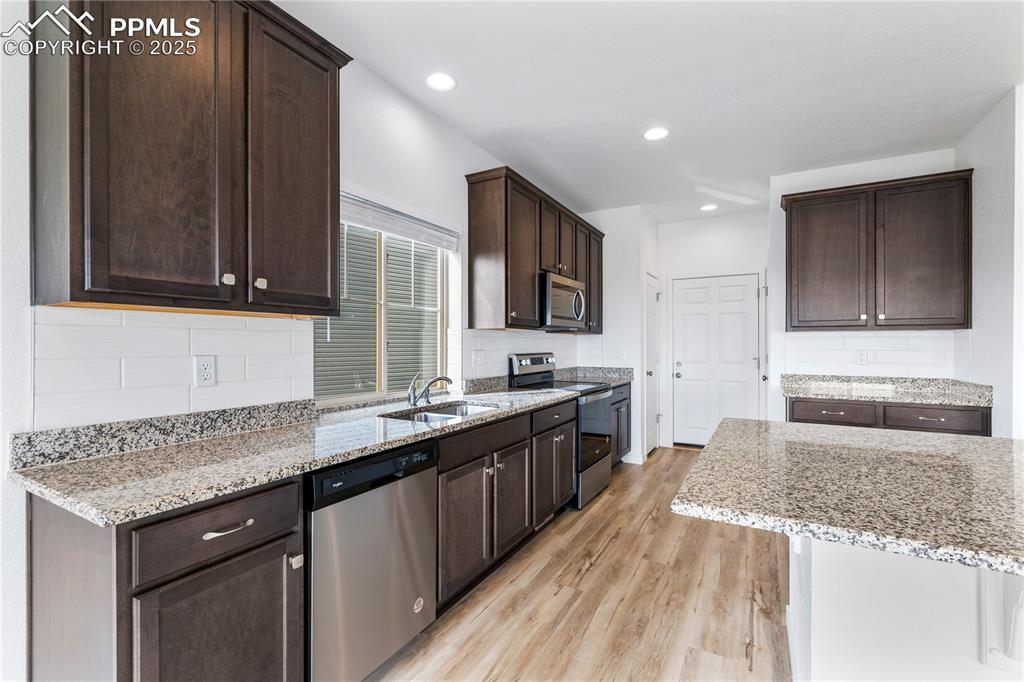 Image 7 of 39: Tons of cabinets and a pantry in the kitchen