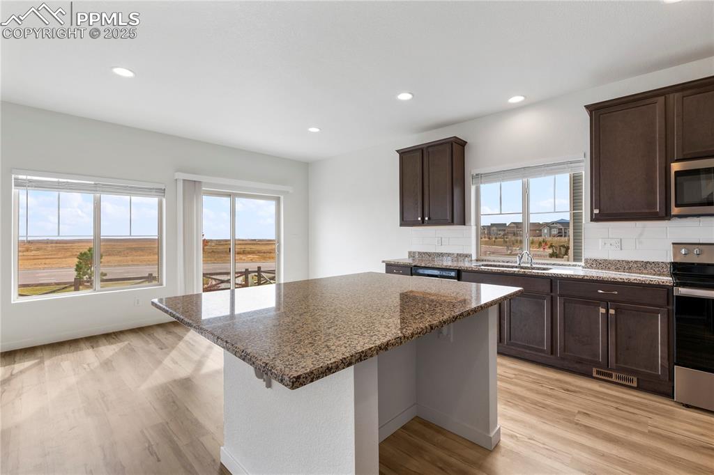 Image 8 of 39: Giant island with solid slab granite counter tops