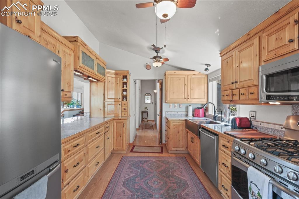Image 16 of 49: Kitchen with light wood-style flooring, a wealth of natural light, applianc