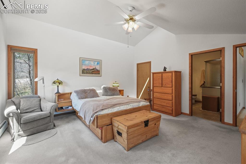 Image 27 of 49: Master Suite with an AC wall unit, light carpet, a baseboard radiator, high