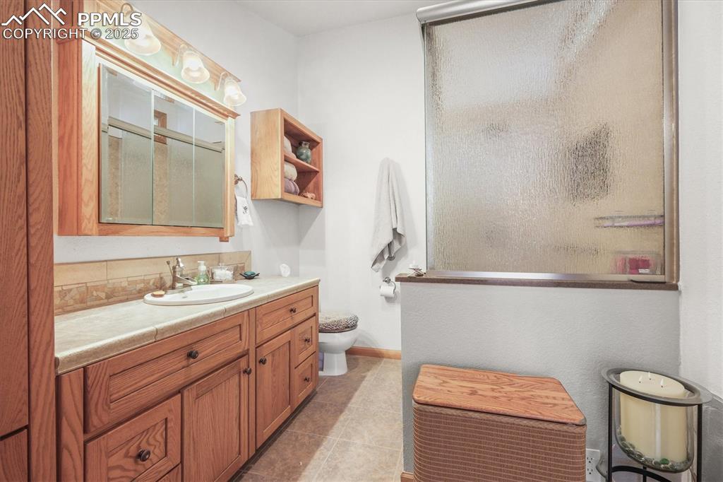 Image 28 of 49: Attached Master Full bathroom with vanity, tile patterned flooring and show