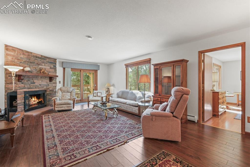 Image 30 of 49: Lower Level Walk-Out area with a baseboard radiator, wood-style floors, and