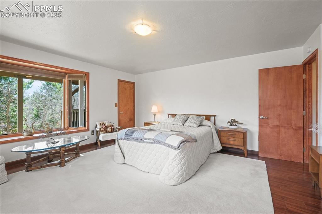 Image 37 of 49: Secondary master suite featuring a bay window and large walk-in closet