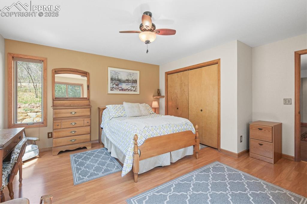 Image 41 of 49: Bedroom featuring a ceiling fan, baseboards, light wood-style flooring, and