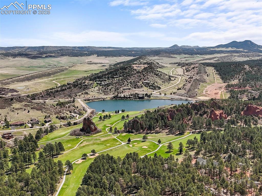 Image 48 of 49: Aerial view featuring Perry Park golf course view and lake with mountain vi